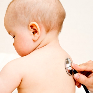 Children's doctor exams infant with stethoscope